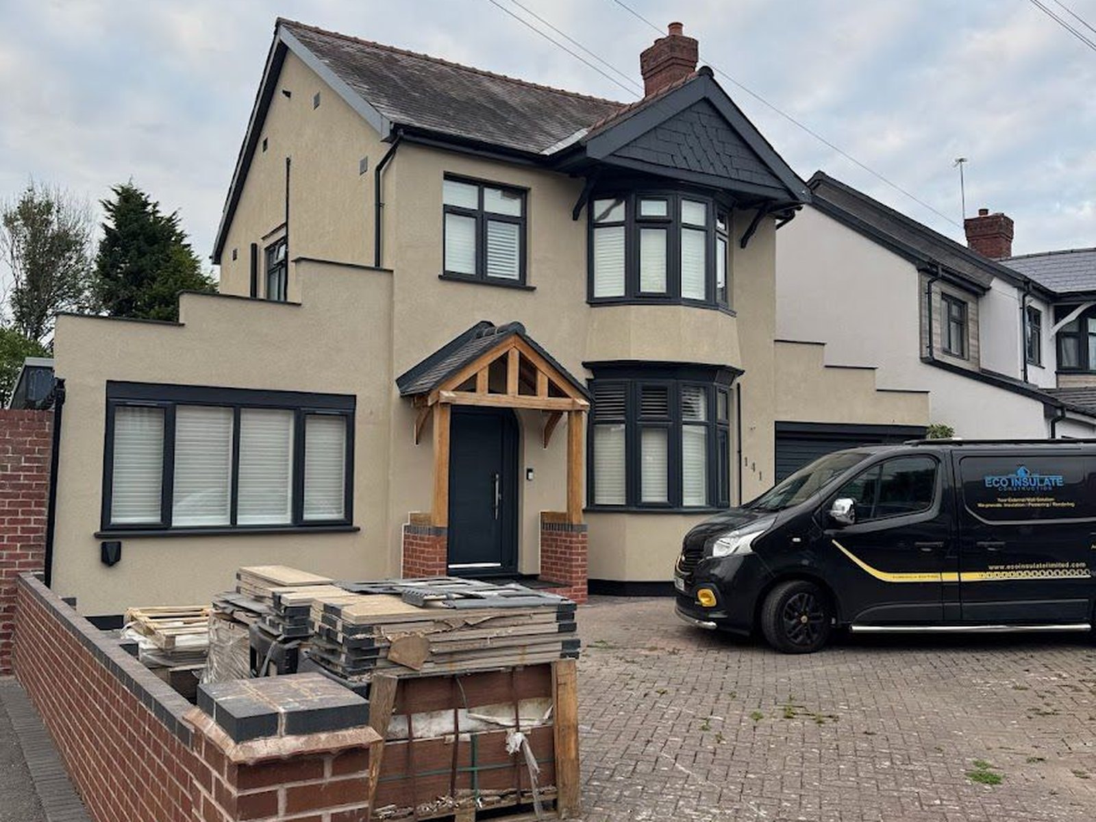 The same house after external wall insulation and a cream silicone render finish