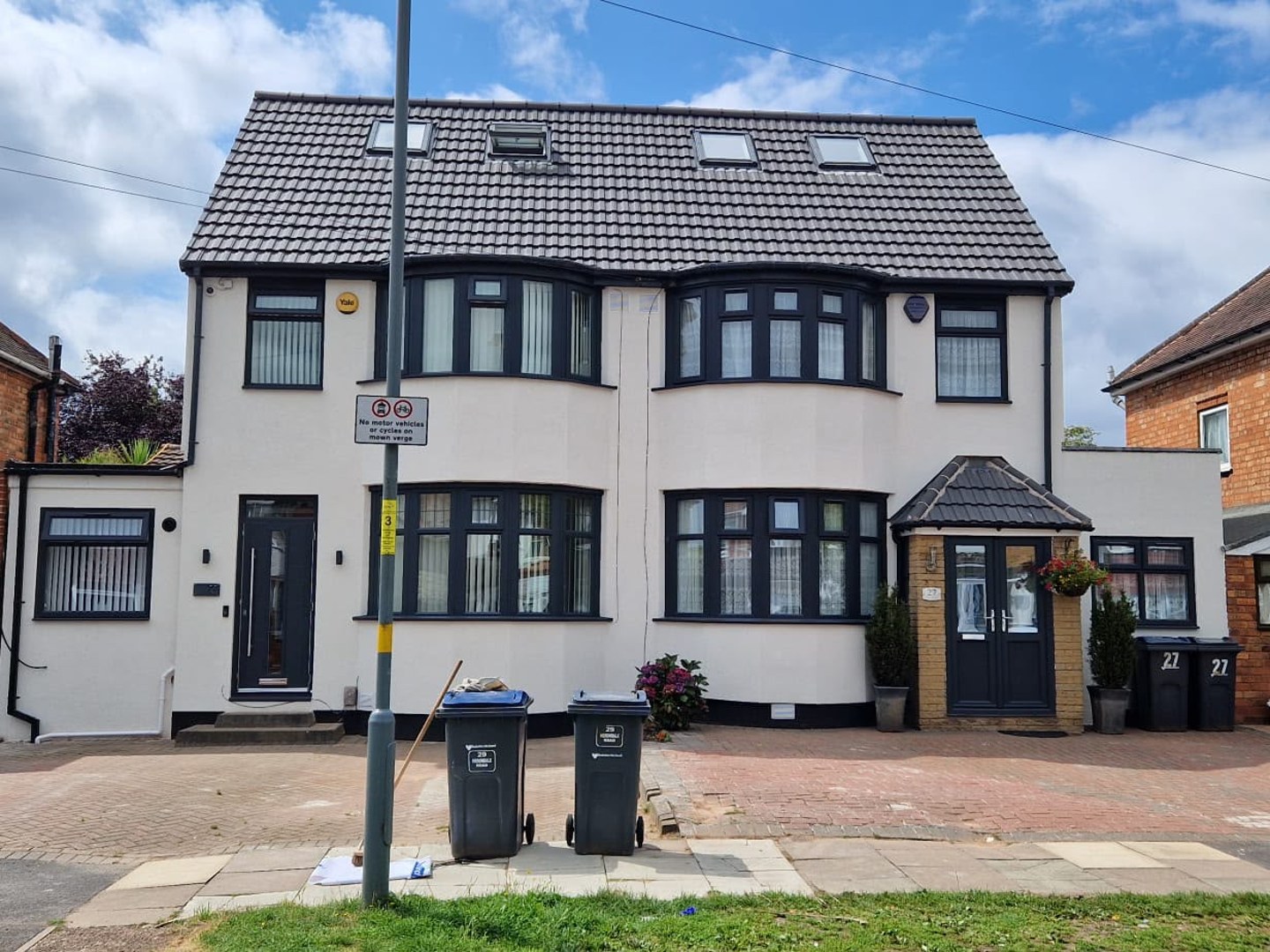 The same house after external wall insulation and a smooth off-white render finish